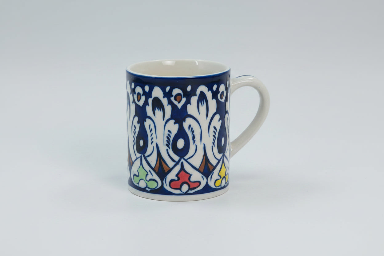 Mug with blue and white floral pattern on a white background